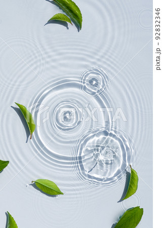 Organic cosmetic background clean transparent waves, water splashes with green leaves 92832346
