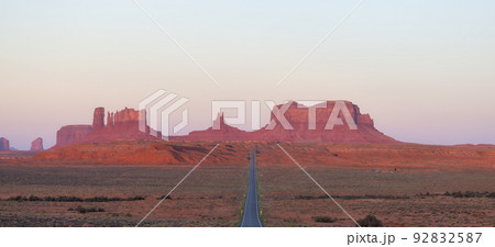 Scenic Road in the Dry Desert with Red Rocky Mountains in Background. Scenic Road in the Dry Desert with Red Rocky Mountains in Background. 92832587