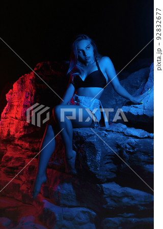 sexy girl in summer clothes in neon light among the rocks sexy girl in summer clothes in neon light among the rocks 92832677