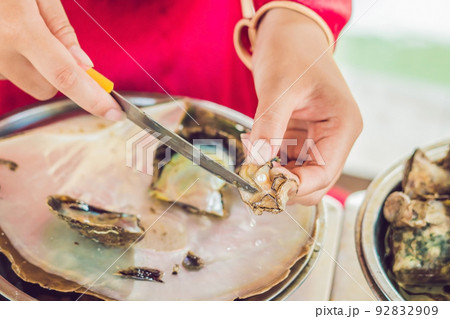 worker take the pearl from the shell worker take the pearl from the shell 92832909