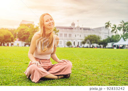 Woman on background of City Hall in George Town - Penang, Malaysia. British built historical building completed 1903 became the City Hall of George Town 1957 92833242