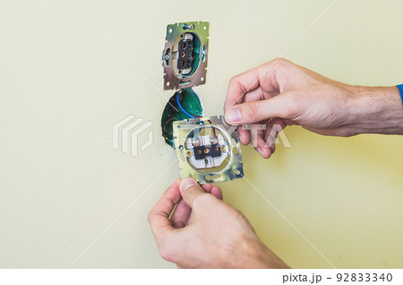 Electrician Installing Socket In New House Electrician Installing Socket In New House 92833340