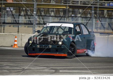 Unknown rider on the car overcomes the track 92833426