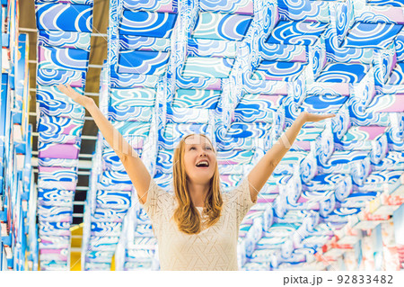 A young European woman in the background of Asian lanterns is celebrating the Chinese New Year 92833482