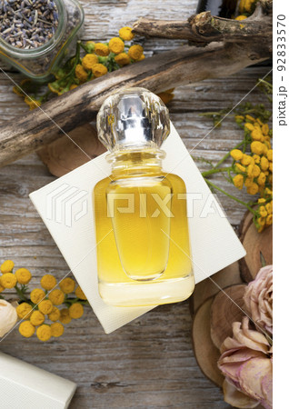 perfume bottles around yellow flowers and ingridients  at  wooden old style background . flat lay. perfumery concept 92833570
