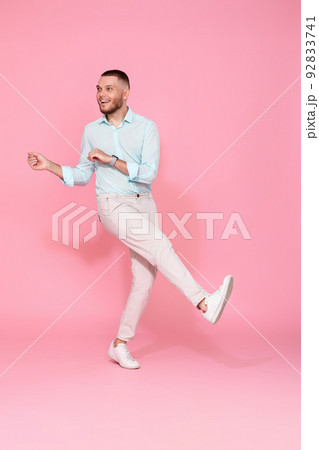 handsome smiling man in blue shirt dancing 92833741