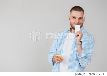 handsome man with smartphone and credit card 92833751
