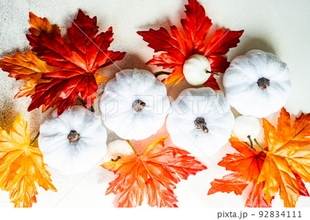 Fake maple leaves on the concrete background Fake maple leaves on the concrete background 92834111