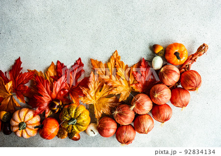 Fake maple leaves on the concrete background Fake maple leaves on the concrete background 92834134