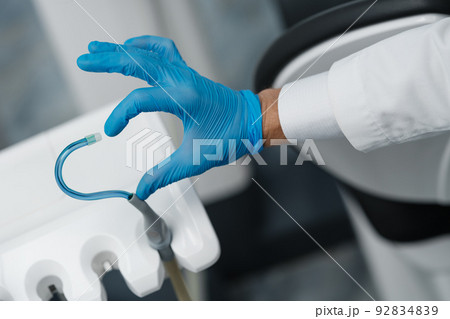 Saliva ejector and a hand form heart shape symbol Saliva ejector and a hand form heart shape symbol 92834839