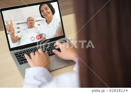 Doctor online video conference with the old elderly patient to monitor and ask for symptoms of the disease And giving advice and consultation of health care, telemedicine and telehealth concept. 92838124