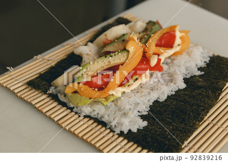 Process of preparing vegan sushi roll futomaki with pepper cucumber and avocado salad 92839216
