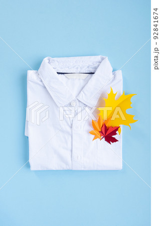 A white shirt with autumn leaves in the pocket. Back to school concept. A white shirt with autumn leaves in the pocket. Back to school concept. 92841674
