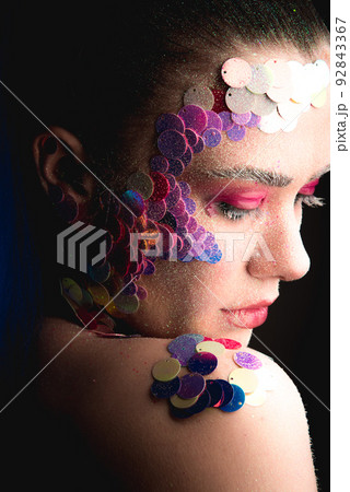 Portrait of a girl with colorful sequins makeup 92843367