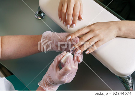 Hands of manicure master and client top view. Master of nail service. Closeup Hands of manicure master and client top view. Master of nail service. Closeup 92844074