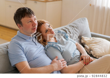 Dreamy married couple happy middle aged people looking into distance, planning Dreamy married couple happy middle aged people looking into distance, planning 92844832