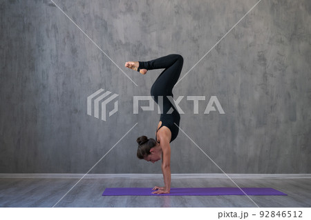 Side view portrait beautiful young woman wearing black sportswear, exercising Side view portrait beautiful young woman wearing black sportswear, exercising 92846512