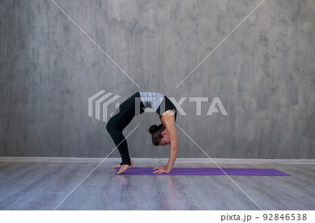 Young yogi woman practicing yoga lesson breathing meditation doing exercises 92846538