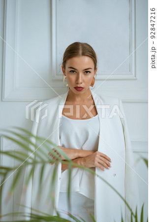 Portrait of smiling confident caucasian business woman in white suit office. 92847216