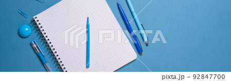 Notebook and pen on a blue background. Top view with copy space. Stationery Notebook and pen on a blue background. Top view with copy space. Stationery 92847700