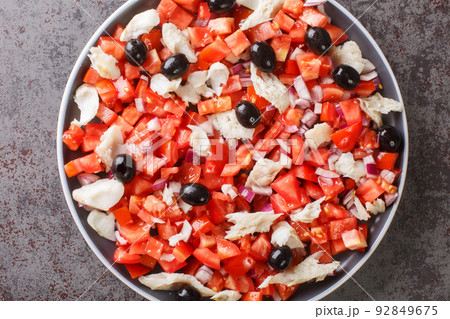 fresh and simple salad with cod and vegetables close-up in a plate. Horizontal top view 92849675