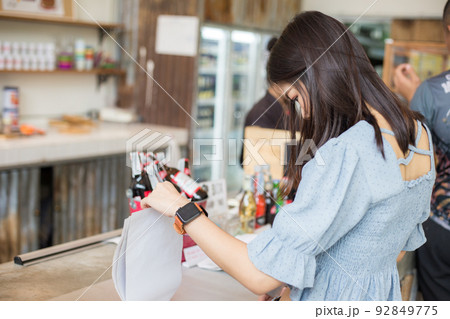 Beautiful women order coffee drink stand on counter in cafe 92849775