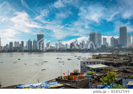 Views of slums on the shores of Mumbai, India against the backdrop of skyscrapers under construction. Views of slums on the shores of Mumbai, India against the backdrop of skyscrapers under construction. 92852595