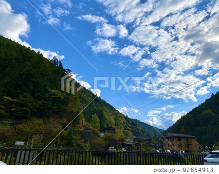 青空と紅葉の山が背景の龍神温泉の風景　和歌山県田辺市 92854913
