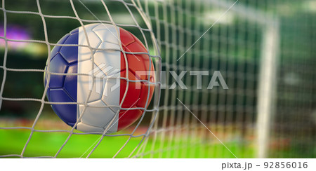 Football ball with flag of France in the net of goal of football stadium. Football championship of FRance concept. 92856016
