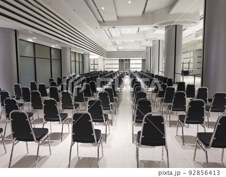 Empty chairs in a modern conference room. Shallow depth of field Empty chairs in a modern conference room. Shallow depth of field 92856413