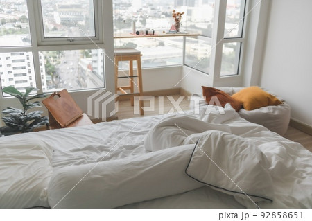 Interior apartment white bedroom with windows and light minimal style. Interior apartment white bedroom with windows and light minimal style. 92858651