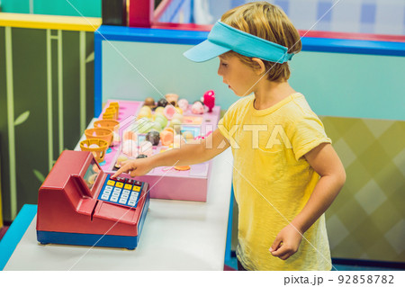 Children play as ice cream seller. 92858782