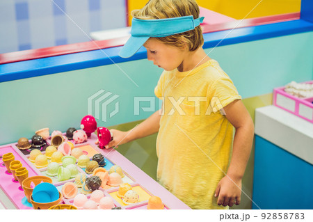 Children play as ice cream seller. 92858783