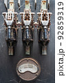 Old, rusty electrical switchboard and ampere meter in an abandoned factory 92859319