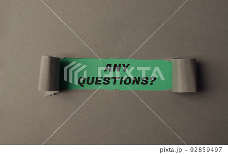 Text Any Questions on green view through torn paper Text Any Questions on green view through torn paper 92859497
