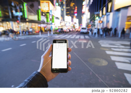 man holding a phone in Manhattan New York City 92860282