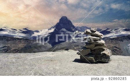 Stack of stones on top of the mountain. Pile of rocks stone and mountains. Balanced stone pyramid or Stacked stone or mountain stones tower. Stones arranged for meditation. Represent spirit of Zen. 92860285