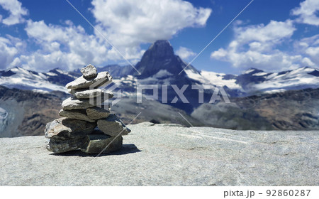 Stack of stones on top of the mountain. Pile of rocks stone and mountains. Balanced stone pyramid or Stacked stone or mountain stones tower. Stones arranged for meditation. Represent spirit of Zen. 92860287