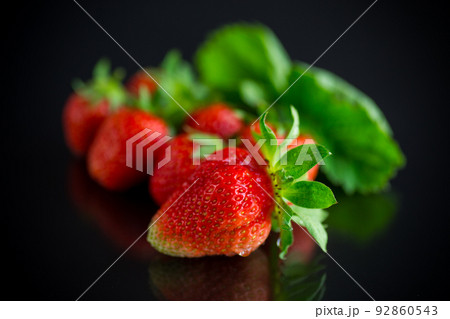 Ripe juicy red strawberry on black background 92860543