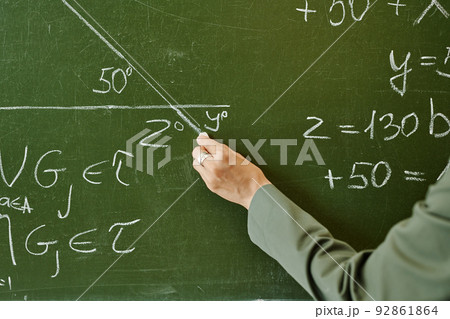 Hand of young teacher of geometry drawing triangle with unknown angle Hand of young teacher of geometry drawing triangle with unknown angle 92861864