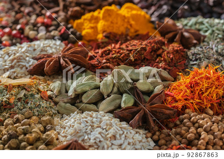 Spices. Aromatic Indian spices on a slate background. Spices and herbs on a stone background. Spices. Aromatic Indian spices on a slate background. Spices and herbs on a stone background. 92867863