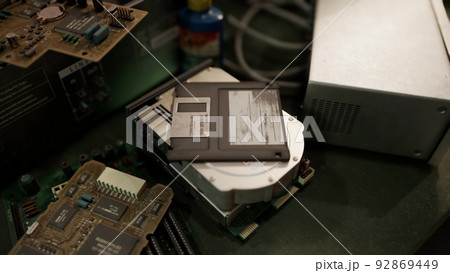 old computer floppy disk and motherboard 92869449