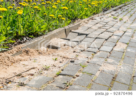 Defective cobblestone pavement due to incorrectly prepared base. Defective cobblestone pavement due to incorrectly prepared base. 92870496