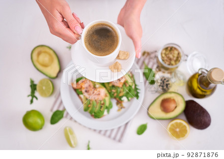 Freshly made Avocado, salmon and cream cheese toasts on a white ceramic plate Freshly made Avocado, salmon and cream cheese toasts on a white ceramic plate 92871876