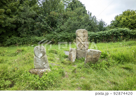 This is a bronze age stone carviing with two faces,called Janus, located In Caldragh Cemetery on Boa Island, Lower Lough Erne. Northern Ireland 92874420