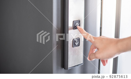 Male forefinger pressing on button up elevator Male forefinger pressing on button up elevator 92875613
