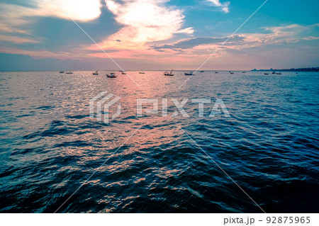 Beautiful sunrise on sea background with tropical wooden fishing boat 92875965