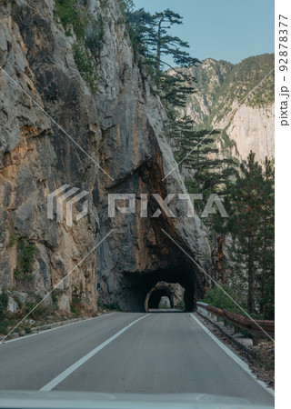 Empty route and small tunnel in mountain 92878377