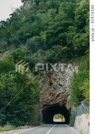Empty route and small tunnel in mountain Empty route and small tunnel in mountain 92878380