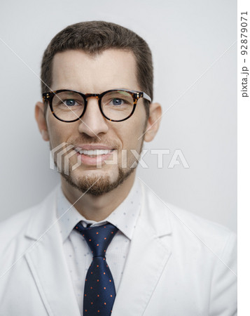 Portrait of happy young bearded male doctor smiling with eyeglasses isolated on white background 92879071